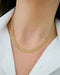 Gold Mesh Necklace in 14k yellow gold styled on neck of model wearing white blouse