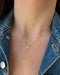 Diamond Butterfly Necklace in 14k yellow gold styled on neck of model wearing denim jacket