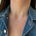 Diamond Butterfly Necklace in 14k yellow gold styled on neck of model wearing denim jacket