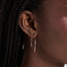 Essential Gold Hoop Earrings in 14k yellow gold styled on earlobe of model