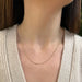 Gold Faceted Ball Chain in 14k yellow gold styled on neck of model wearing tan sweater