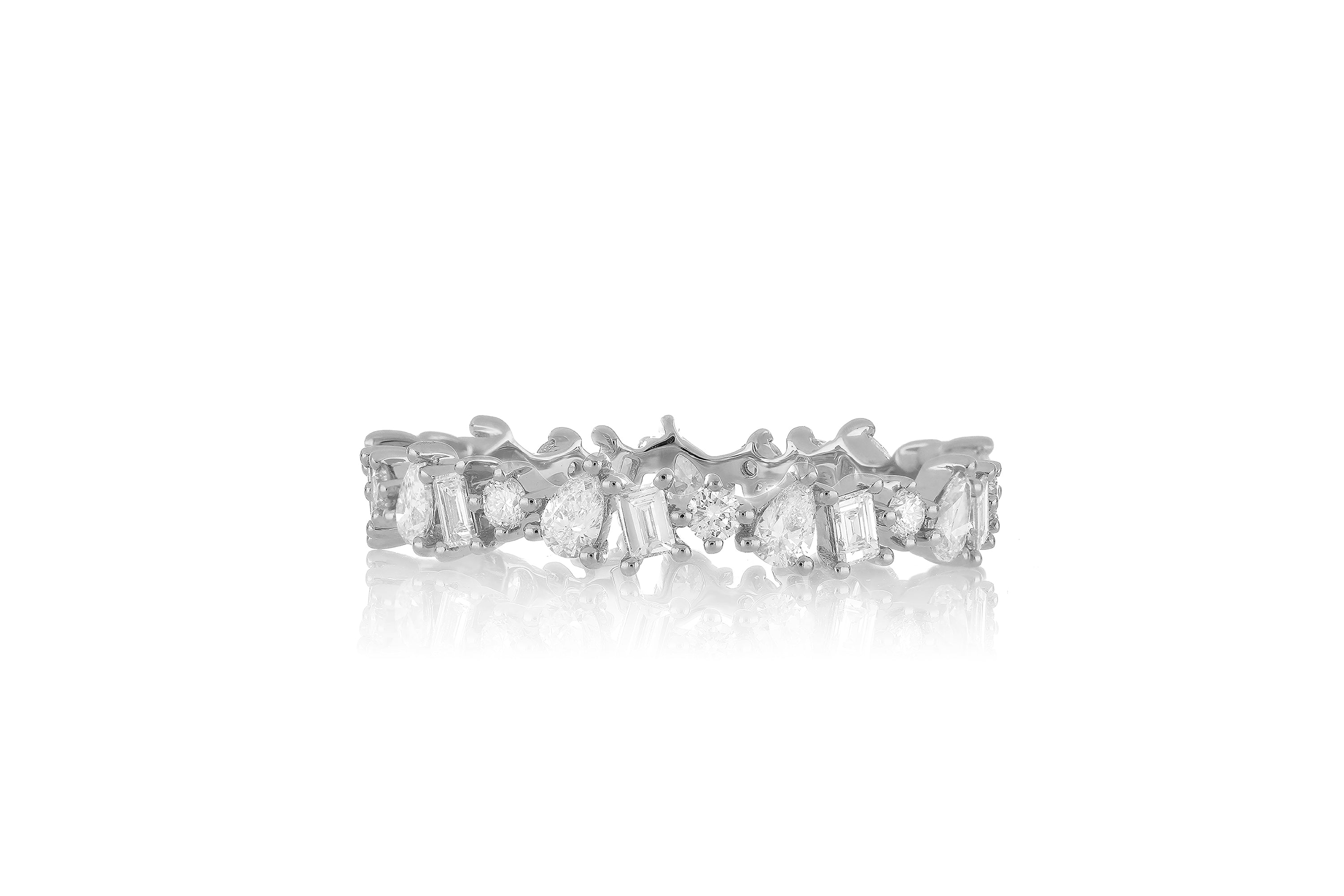 14k white gold multi faceted diamond ring with baguette diamonds, pear shaped diamonds, and round diamonds all around.