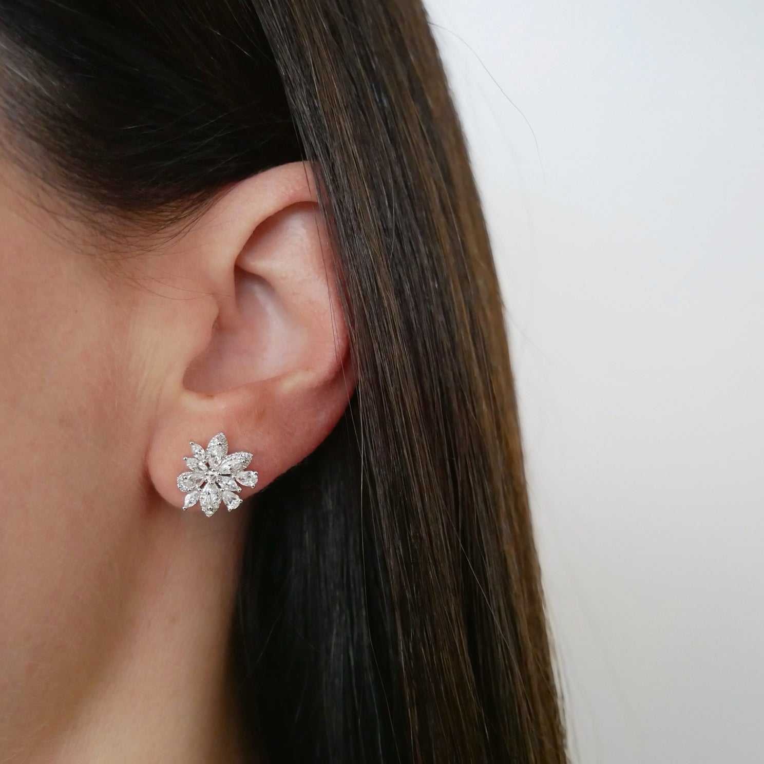 Marquise Diamond Cluster Stud Earrings in 14k white gold styled on ear of model