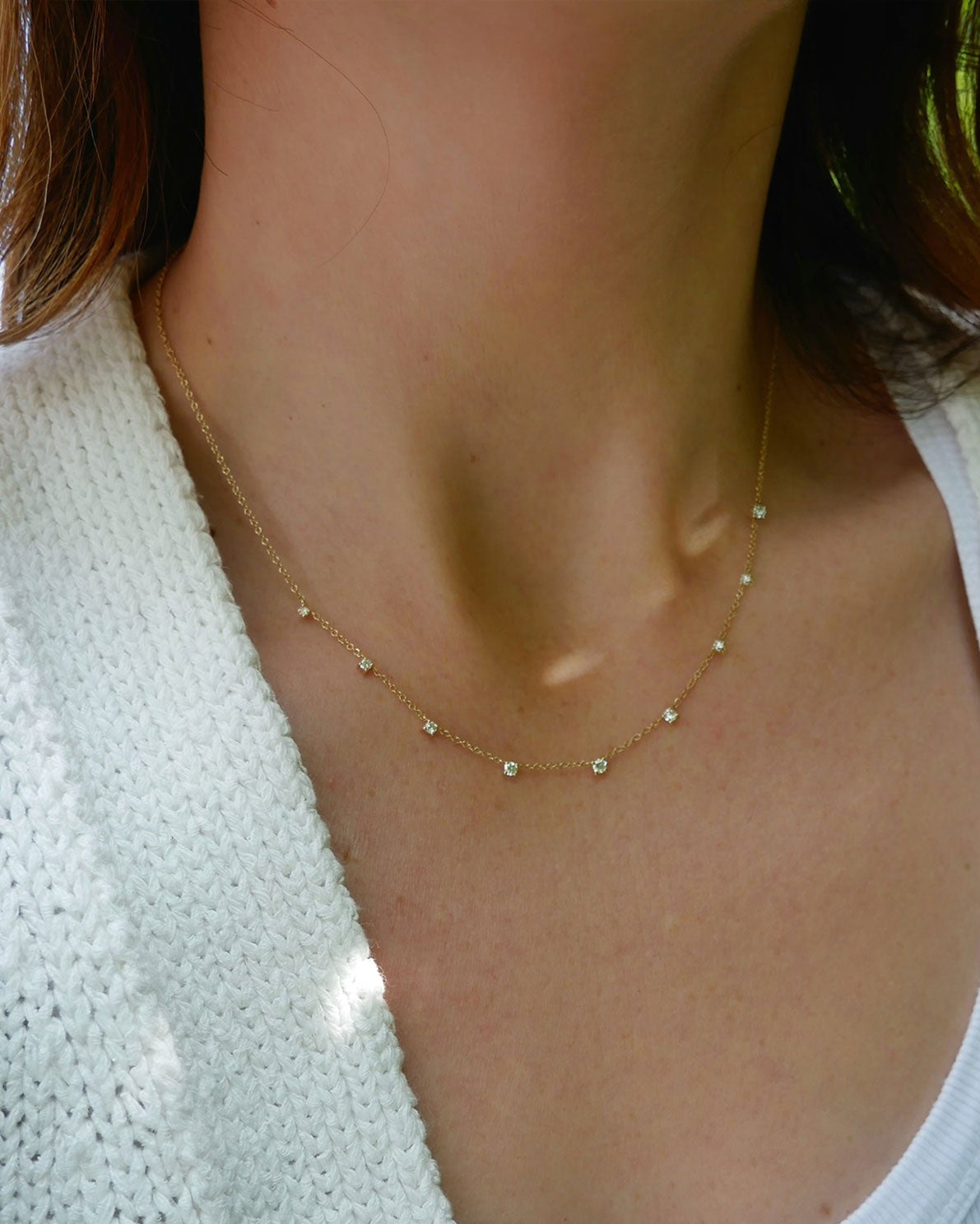 9 Prong Set Diamond Necklace in 14k yellow gold styled on neck of model