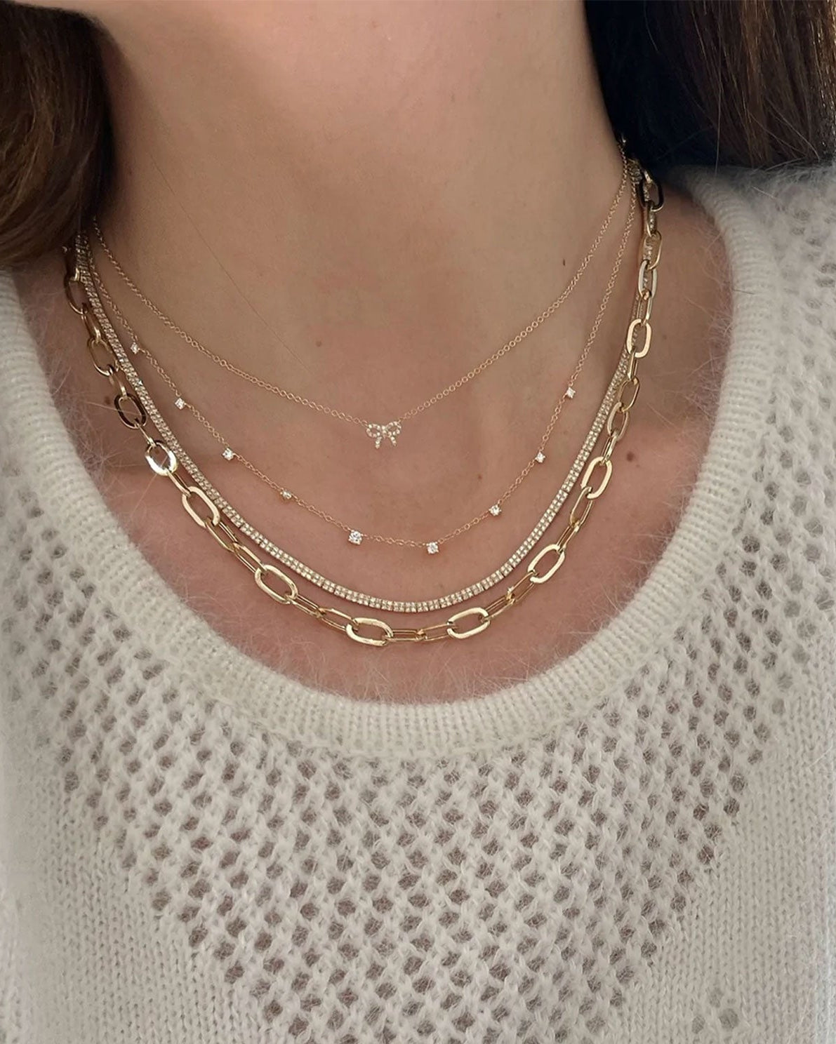 9 Prong Set Diamond Necklace in 14k yellow gold styled on neck of model with diamond and gold necklaces