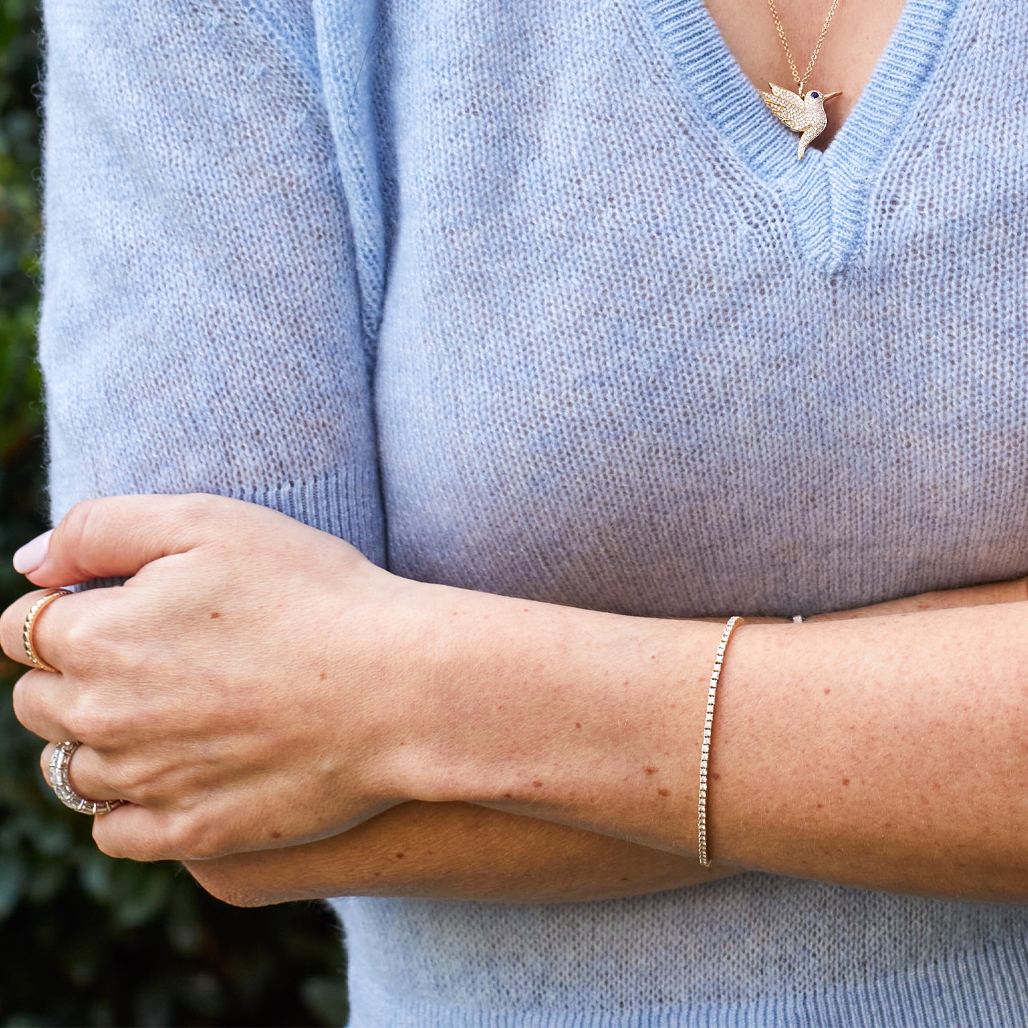 Diamond Grace tennis Bracelet styled on wrist of model in blue sweater