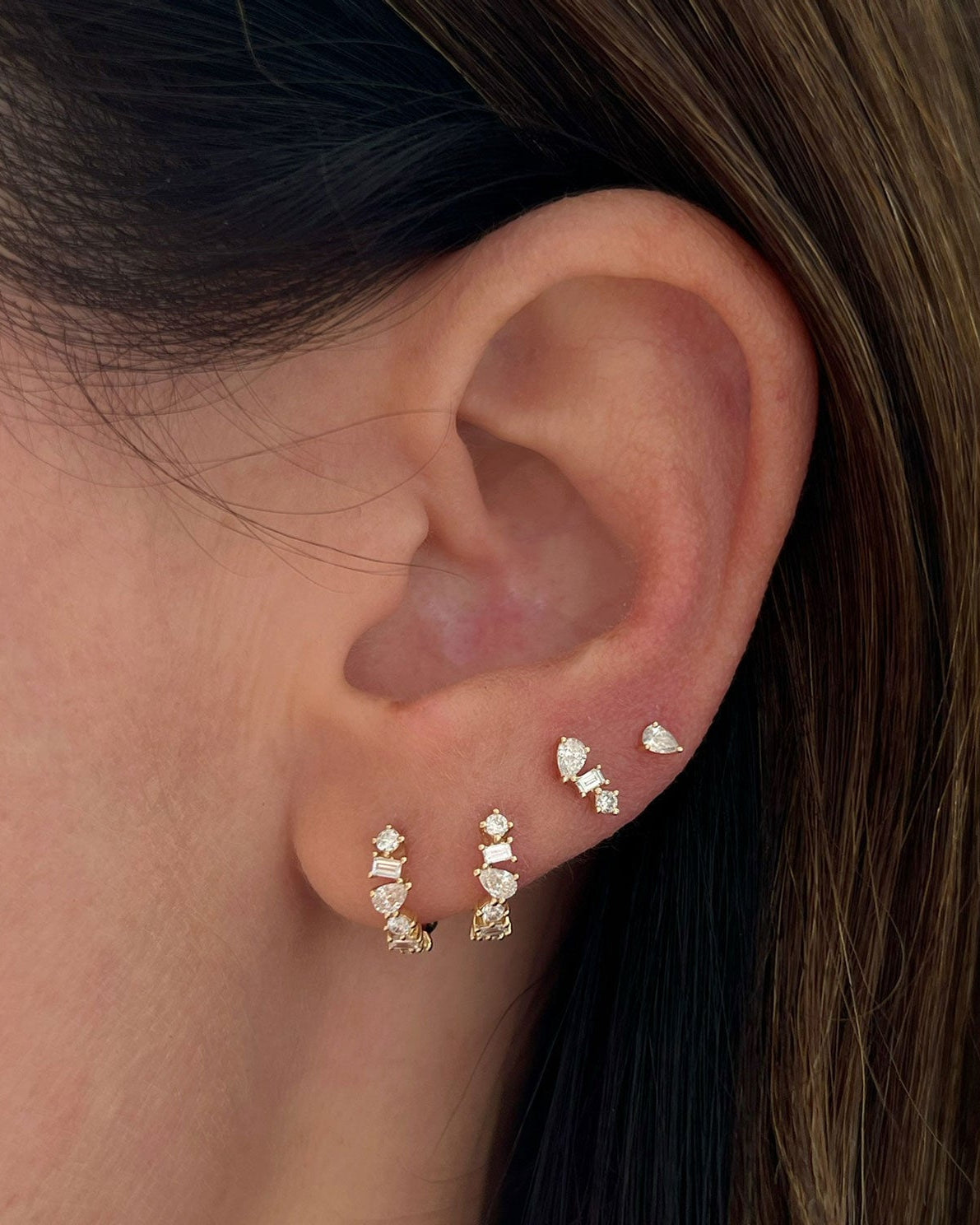 Multi Faceted Diamond Stud Earring in 14k yellow gold styled on ear of model