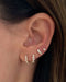Multi Faceted Diamond Stud Earring in 14k yellow gold styled on ear of model