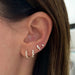 Multi Faceted Diamond Stud Earring in 14k yellow gold styled on ear of model