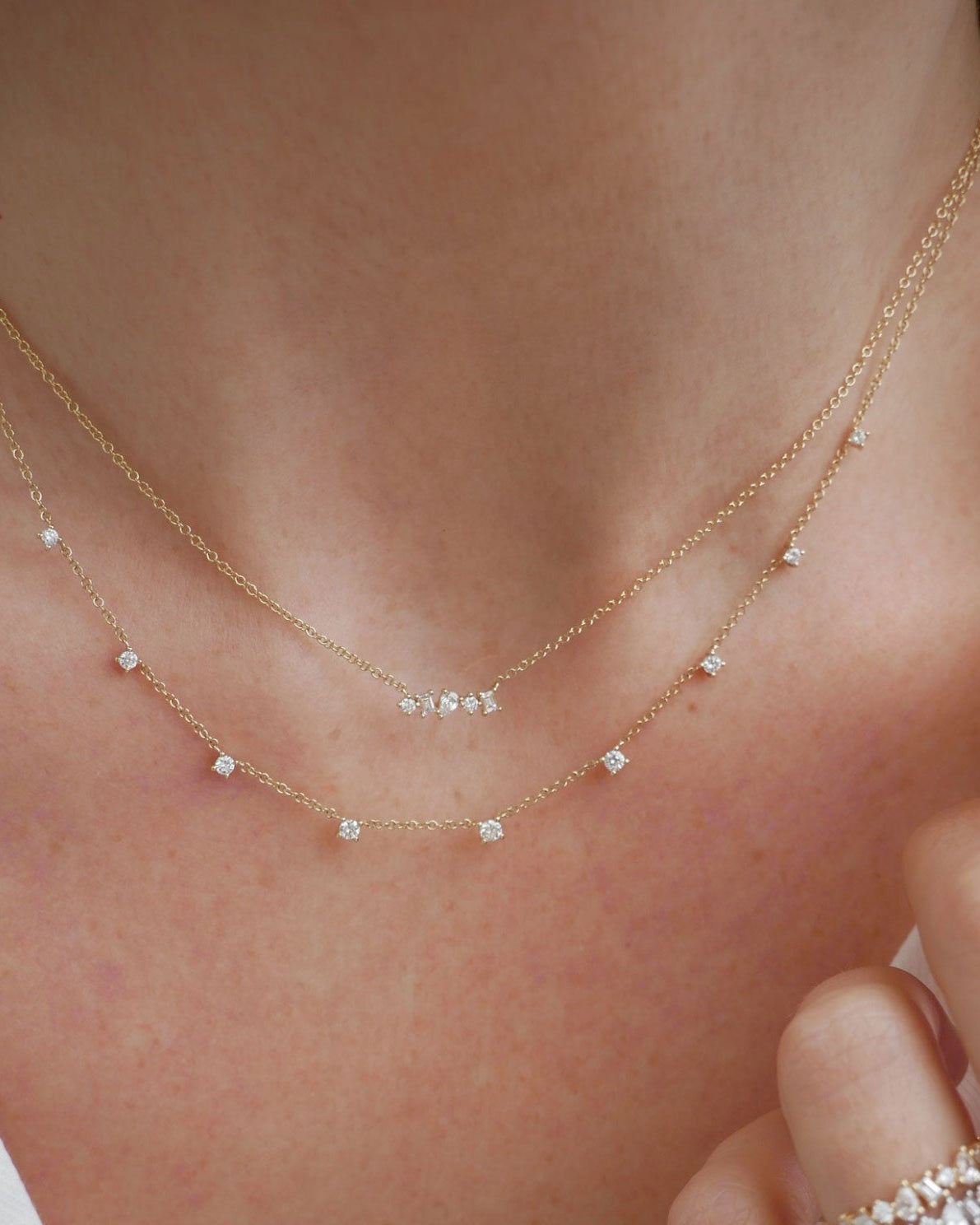Diamond Multifaceted Mini Bar Necklace in 14k yellow gold styled on neck of model with 9 prong diamond necklace