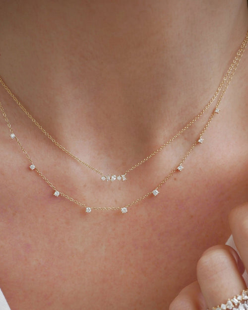 Diamond Multifaceted Mini Bar Necklace in 14k yellow gold styled on neck of model with 9 prong diamond necklace