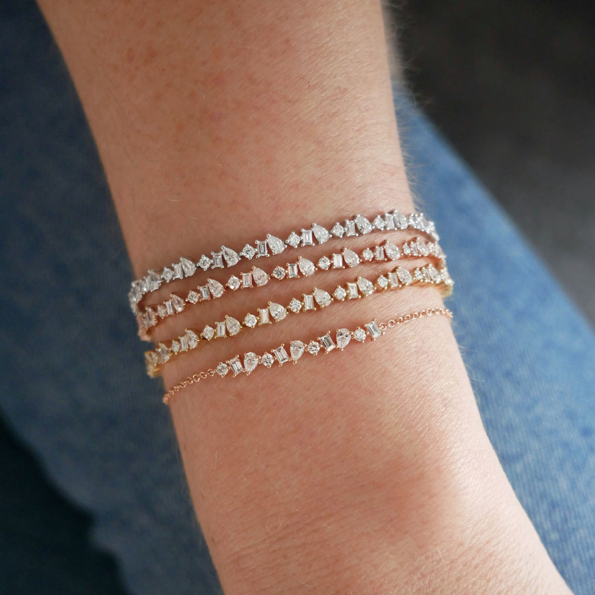 Diamond Multifaceted Eternity Bracelet in 14k yellow, rose, and white gold styled on wrist of model next to multifaceted bracelet in yellow gold