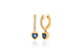 Mini huggie earrings with diamond encrusted hoops with a 5mm blue sapphire heart shaped charm at the bottom  in 14k (carat) yellow gold. Overall dimensions: 15 mm