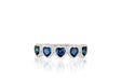 14k (karat) white gold ring with 5 blue sapphire jeweled hearts circling the top of the ring.