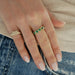 Emerald Multi Heart Ring in 14k yellow gold styled on ring finger of model styled with diamond heart signet ring on pinky ring on hand of model