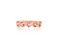 14k (karat) rose gold ring encircled in heart-shaped pendants on the top and featuring a pink sapphire jewel in the center of each heart.