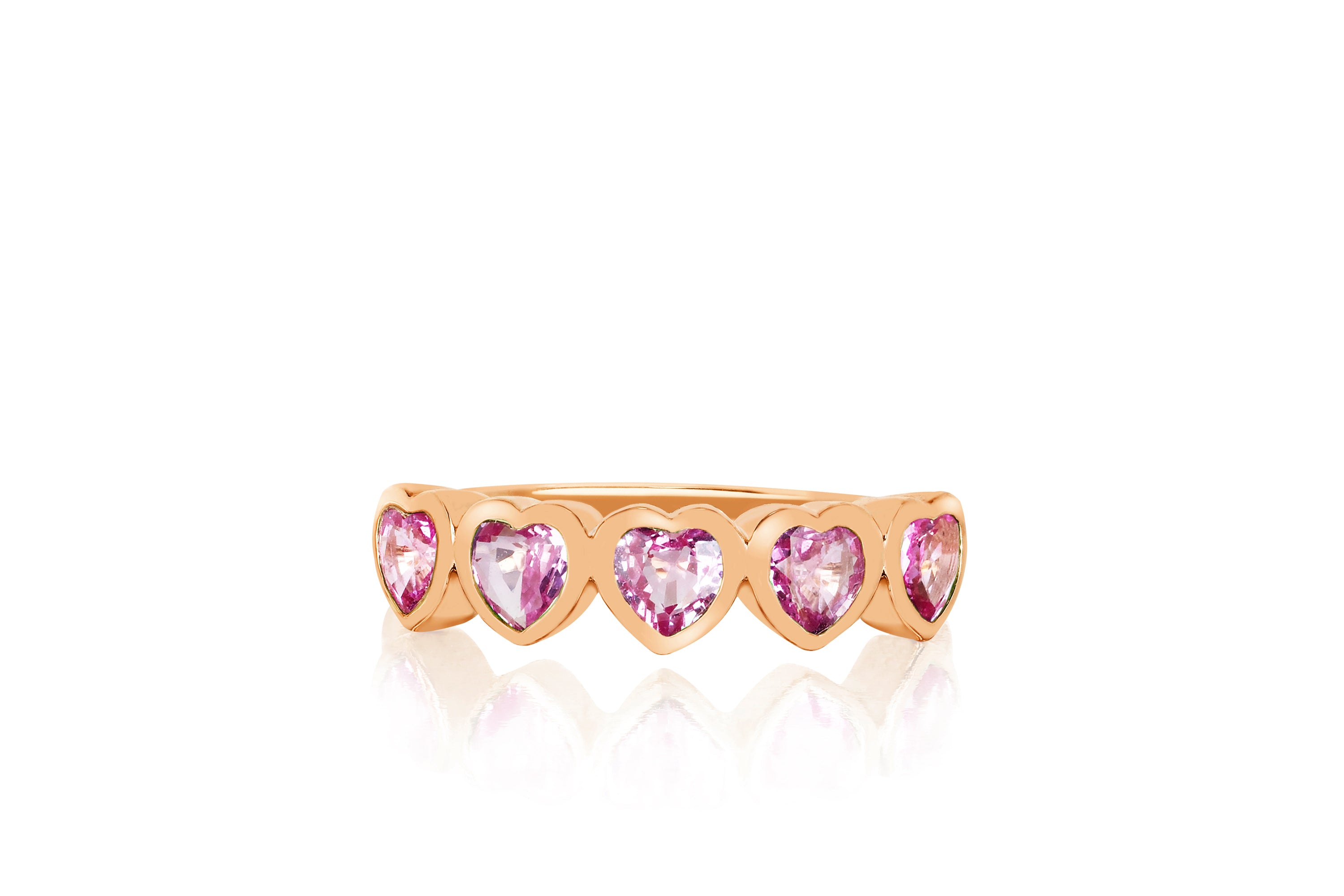 14k (karat) rose gold ring encircled in heart-shaped pendants on the top and featuring a pink sapphire jewel in the center of each heart.