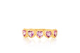 14k (karat) yellow gold ring encircled in heart-shaped pendants on the top and featuring a pink sapphire jewel in the center of each heart.