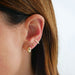 Gold Bubble Huggie Earring 14k yellow gold styled on ear of model with brown hair