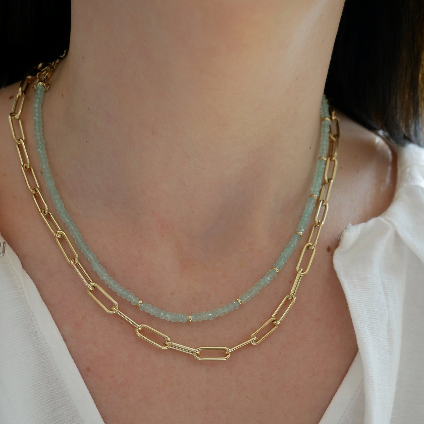 Birthstone Bead Necklace In Chalcedony styled on neck of model with gold lola chain necklace