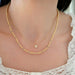 Birthstone Bead Necklace In Diamond in 14k yellow gold styled on neck of model with diamond disc necklace