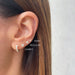 Jumbo Solitaire Diamond Stud Earring in 14k yellow gold styled on second earring hole on ear lobe of model with three other earrings