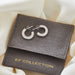 Diamond Harper Hoop Earrings in 14k white gold laying on top of EF Collection grey suede pouch with gold foil logo