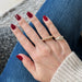 Gold Jumbo Ball Stack Ring in 14k yellow gold styled on ring finger of model next to diamond signet ring on pinky ring