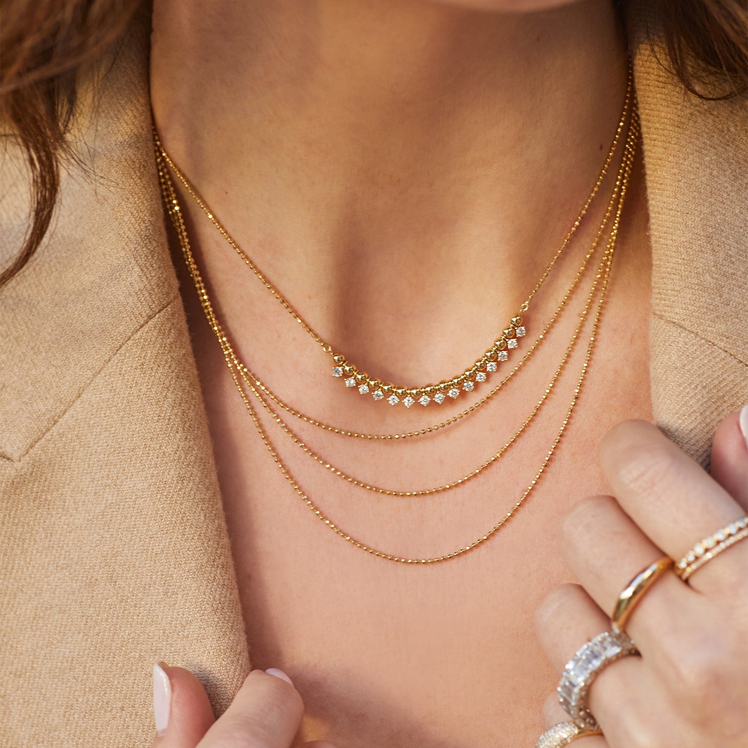 Diamond & Gold Ball Necklace in 14k yellow gold styled with layering necklace on neck of model