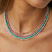Treasure Bar Necklace in 14k yellow gold styled on neck of model wearing three beaded necklaces