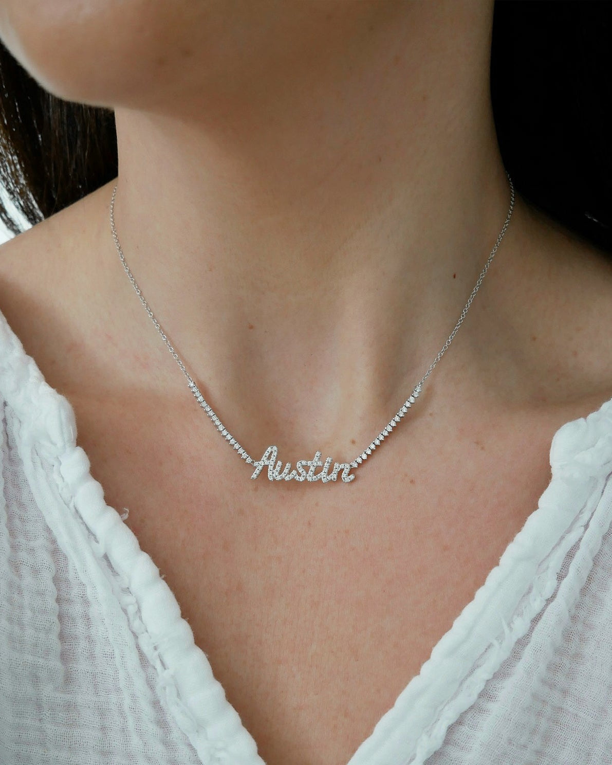 Luxe Diamond Script Name Necklace in 14k white gold with initials AUSTIN styled on neck of model