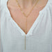 Graduated Chain Link Lariat Necklace in 14k yellow gold styled on neck of model wearing white blouse
