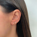 Full Cut Diamond Mini Teardrop Stud Earring in 14k yellow gold styled on ear lobe of model with brown hair