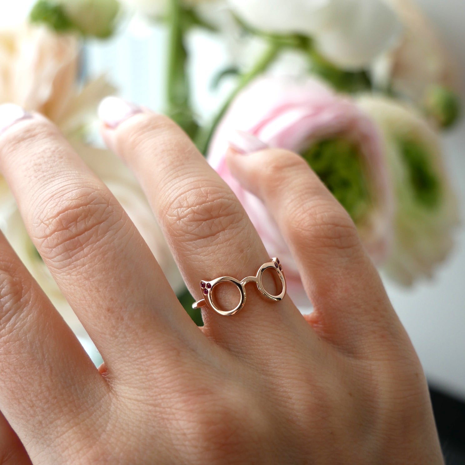 Evan's Sunnies Ring with Rubies in 14k yellow gold styled on ring finger of model