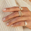 Gold and Diamond Jumbo Double Dome Ring in 14k yellow gold styled on index finger of model next to stacked diamond and gold ball rings