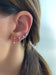 Double Pear Diamond Earring in 14k Yellow Gold Styled on Ear with Additional Earrings 