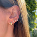 Gold Bubble Huggie Earring in 14k yellow gold styled on ear with brown hair