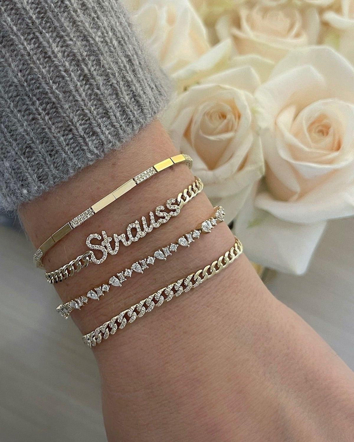 Diamond Script Name Curb Chain Bracelet on the wrist in yellow gold