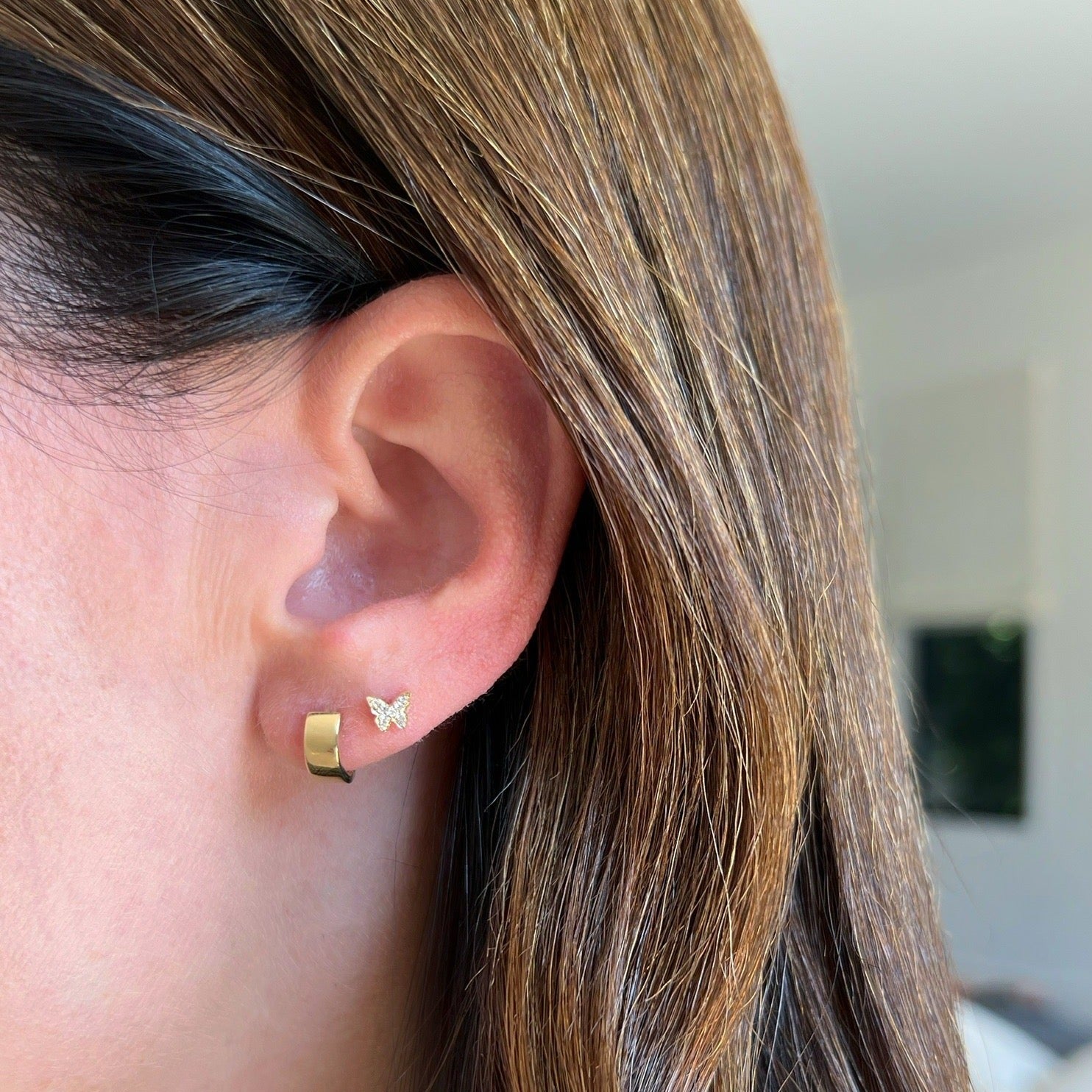 Baby Diamond Butterfly Stud Earring in yellow gold on the ear