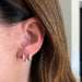 Diamond Dome Huggie Earring on the ear