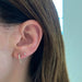 Mini Diamond Hook Earring in yellow gold on the ear