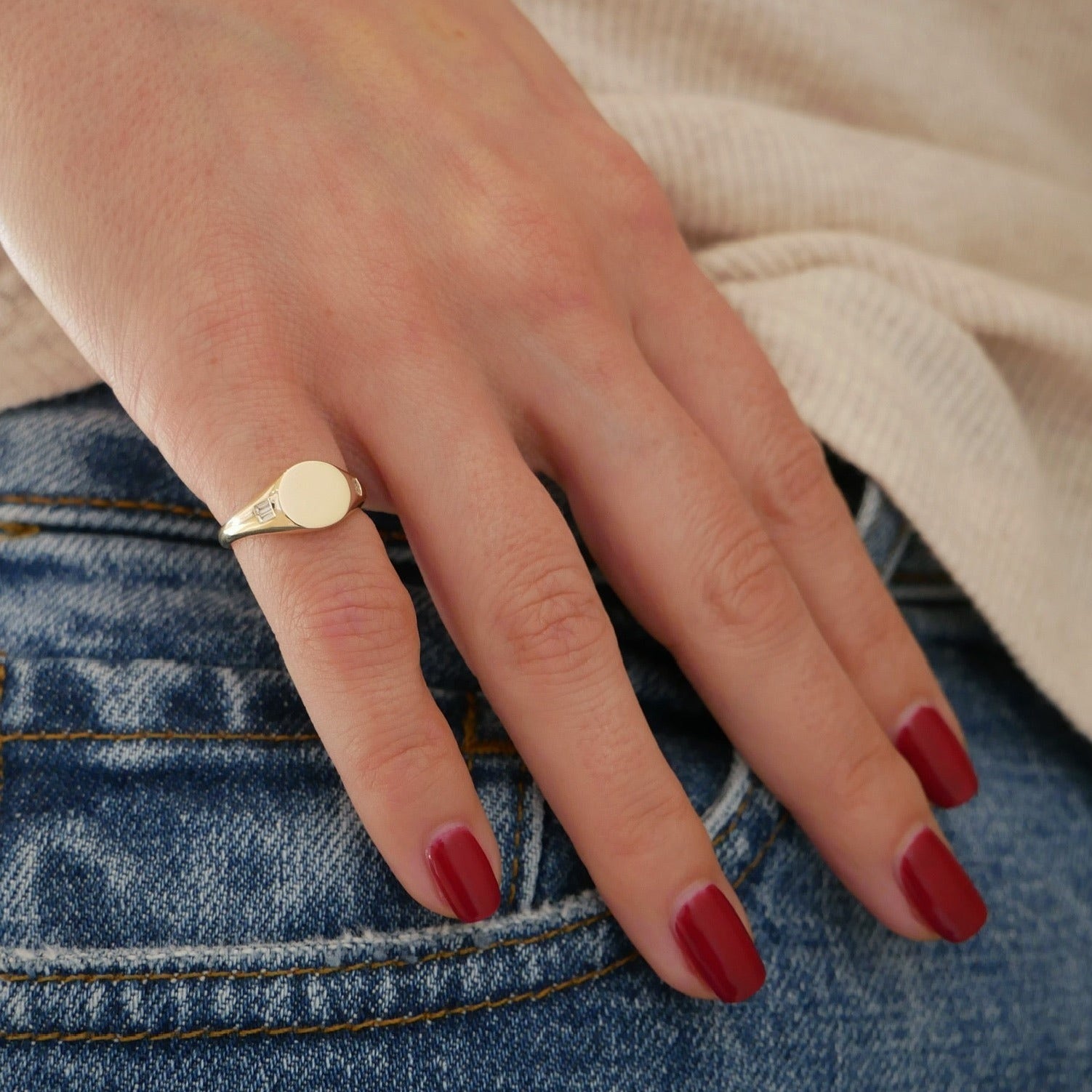 Diamond Baguette Signet Ring in 14k yellow gold styled on pinky ring of hand of model