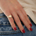 Diamond Baguette Signet Ring in 14k yellow gold styled on pinky ring of hand of model