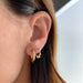 Sasha Hoop Earring styled on the ear in yellow gold