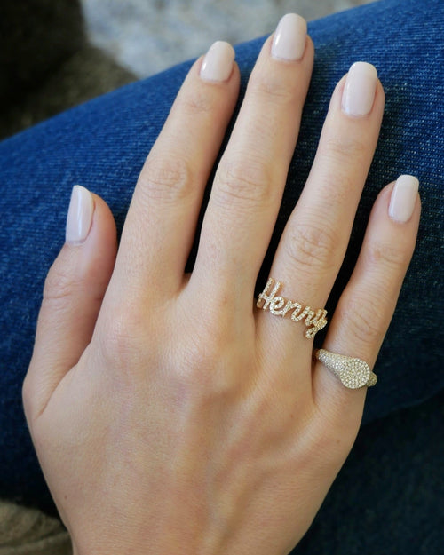 Diamond Script Name Ring on the hand in yellow gold