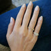 Diamond Script Name Ring on the hand in yellow gold