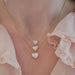 Diamond Heart Solitaire Necklace in 14k white gold with 1.02 carat heart shaped diamond and 18k yellow gold 2.02 carat heart shaped diamond and 18k yellow gold chain with 3.01 heart shape diamond styled on neck of model