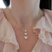 Diamond Heart Solitaire Necklace in 14k white gold with 1.02 carat heart shaped diamond and 18k yellow gold 2.02 carat heart shaped diamond and 18k yellow gold chain with 3.01 heart shape diamond styled on neck of model