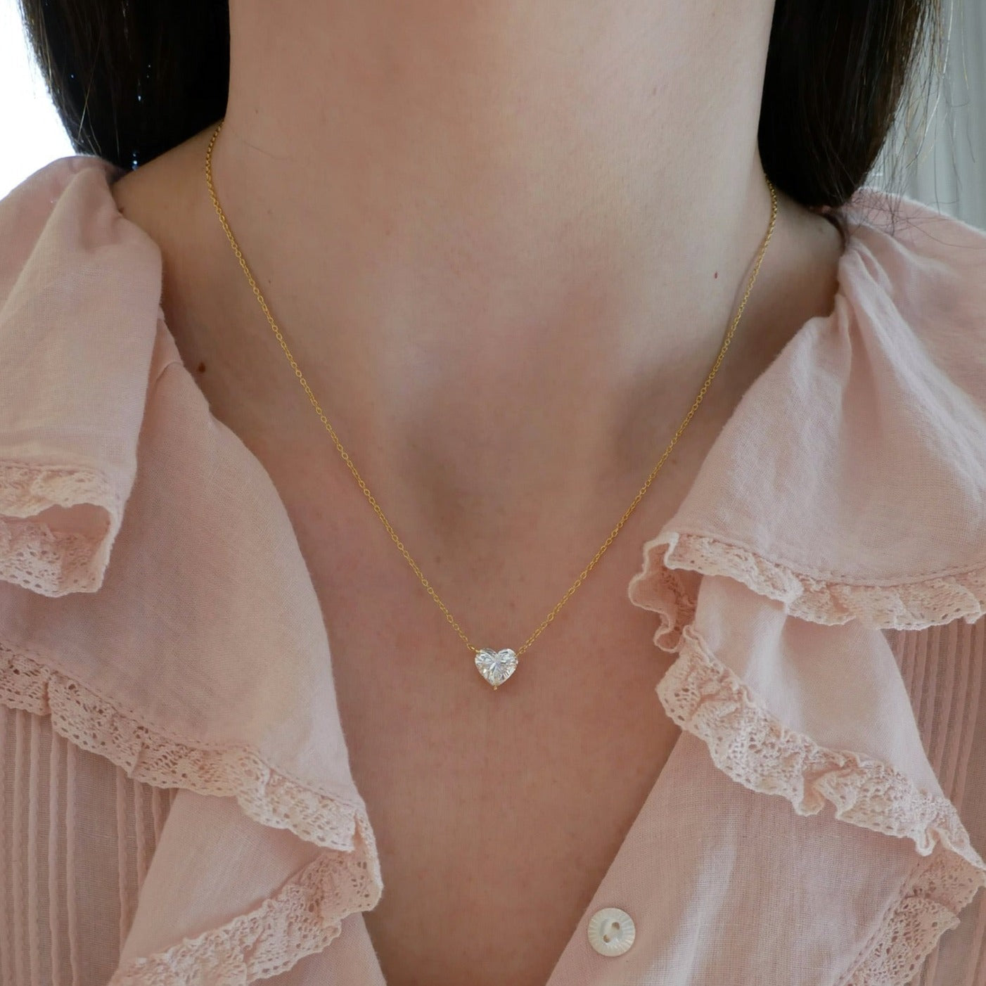 Diamond Heart Solitaire Necklace in 18k yellow gold with 2.02 carat heart shaped diamond styled on neck of model