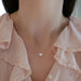 Diamond Heart Solitaire Necklace in 18k yellow gold with 2.02 carat heart shaped diamond styled on neck of model